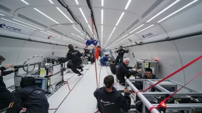 Plusieurs personnes en apesanteur à bord d'un avion.